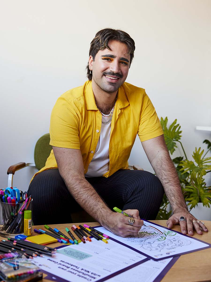 Nick Tsekouras smiling while colouring in his activity