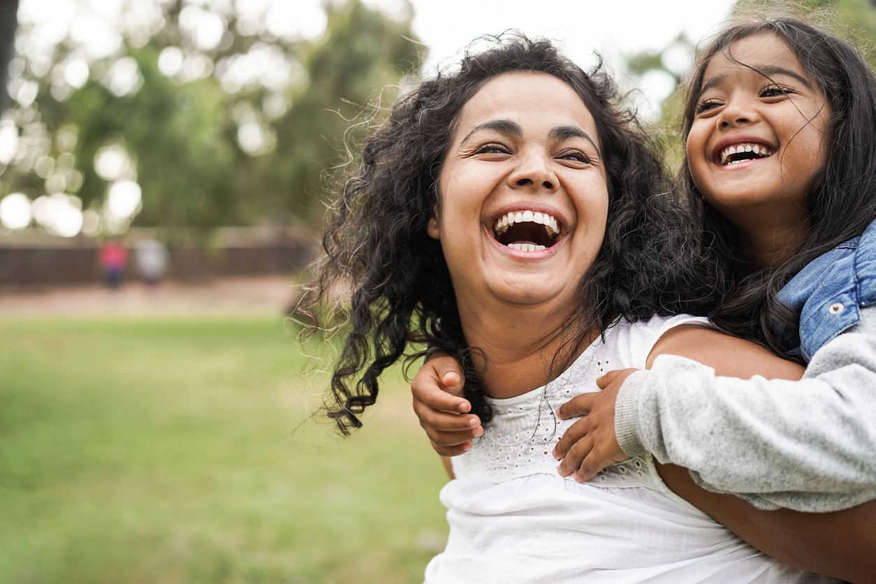 Happy mother having fun with her daughter outdoor